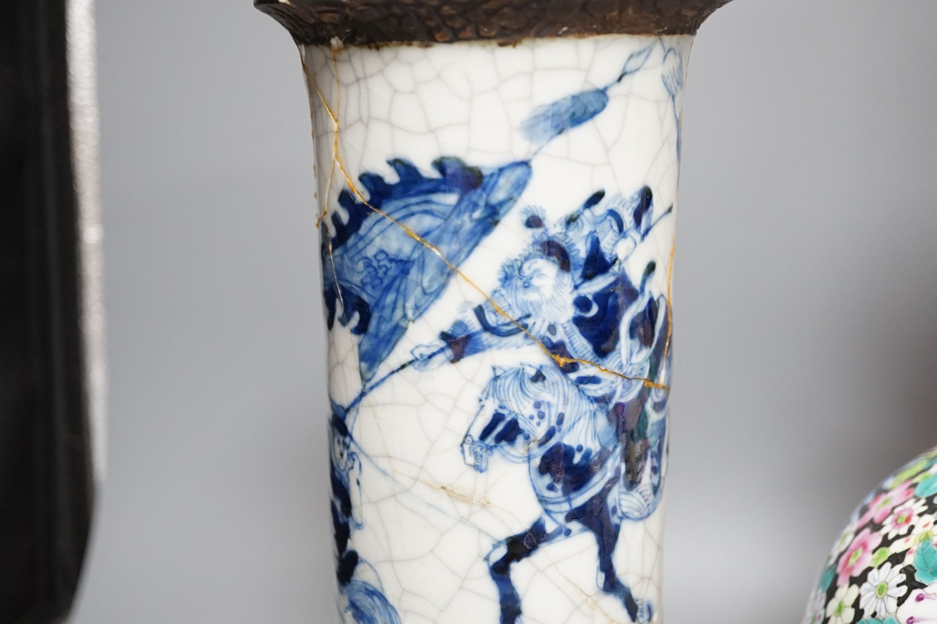 An early 20th century Chinese famille rose thousand flowers bottle vase (restored) together with a Chinese blue and white crackle glazed sleeve vase (a.f)., tallest 40cm
